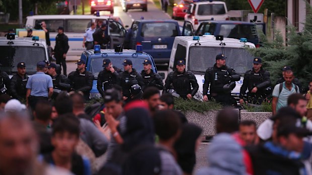 Refugees are turned back by Slovenian police from a small  border crossing in the Croatian village of Bregana.