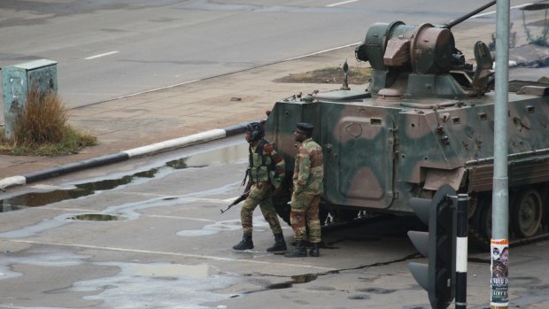 A military tank is seen with armed soldiers on the road leading to President Robert Mugabe's office in Harare, on Wednesday.