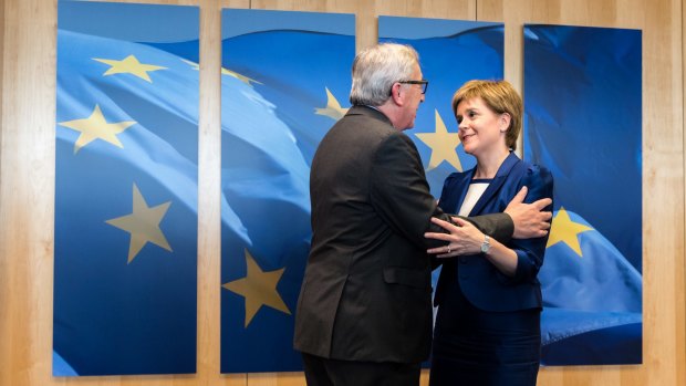 European Commission President Jean-Claude Juncker greets Scottish First Minister Nicola Sturgeon upon her arrival at his office at EU headquarters.