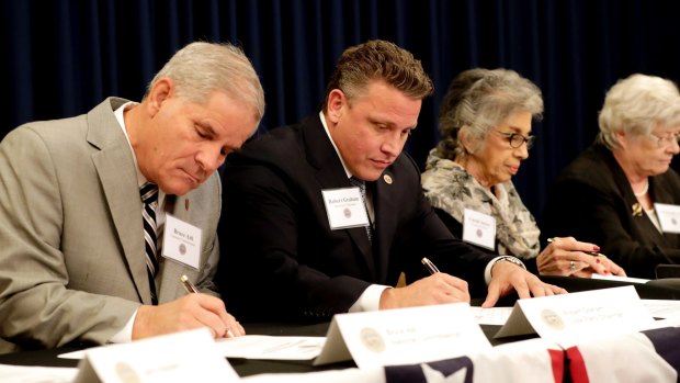 From left; Arizona Electoral College members Bruce Ash, Robert Graham, Carol Joyce, and Jane Pierpoint Lynch, cast their ballots for President-elect Donald Trump at the Capitol in Phoenix.