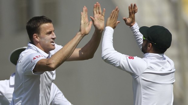 South Africa's Morne Morkel celebrates with teammate Jean-Paul Duminy after claiming the wicket of Indian batsman Murali Vijay.