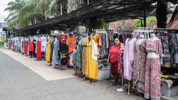 A shopkeeper waits for customers at a market in Seminyak.