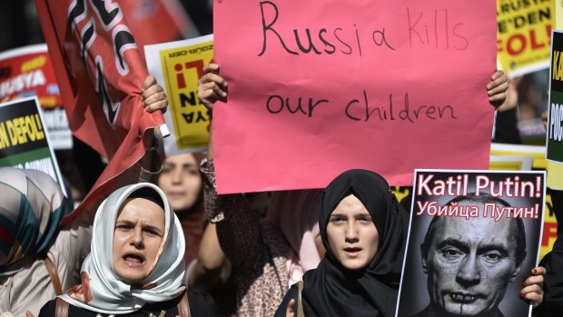 Demonstrators in Istanbul hold placards and a picture depicting "Killer Putin" during a protest against Russian military operations in Syria in October 2015.