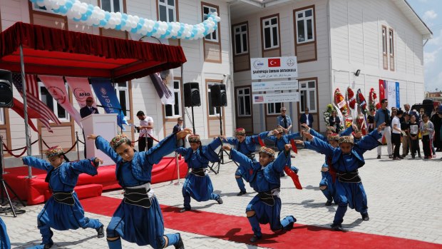 Syrian refugee children at the Sakirpasa Umran school, funded by the US government, dance during its opening ceremony in Adana, southern Turkey, in May.