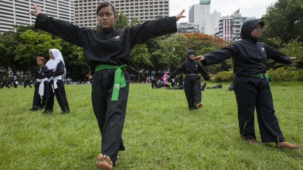 Indonesians working abroad as maids encounter exploitation and abuse. Here they learn self-defence on their day off in Victoria Park, Hong Kong. 
