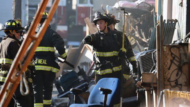 Firefighters assess the scene where a deadly fire tore through a late-night electronic music party in a warehouse in Oakland, California in the early hours of Saturday.