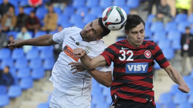 Heads up: Western Sydney Wanderers' Daniel Alessi and ES Setif's Mohamed Benyettou jump for the ball.