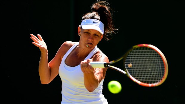 Casey Dellacqua plays a forehand during her first-round match against Tamira Paszek of Austria on Tuesday.