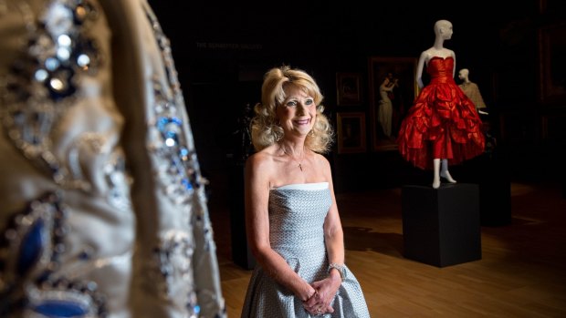 Krystyna Campbell-Pretty with a beaded Christian Dior dress, left, and red Molyneux creation, part of the $1.4 million collection of haute couture fashion she has donated to the NGV.