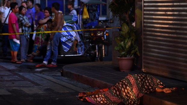 One of two people killed in a double shooting in the Manila suburb of Baclaran is left lying in the street. 