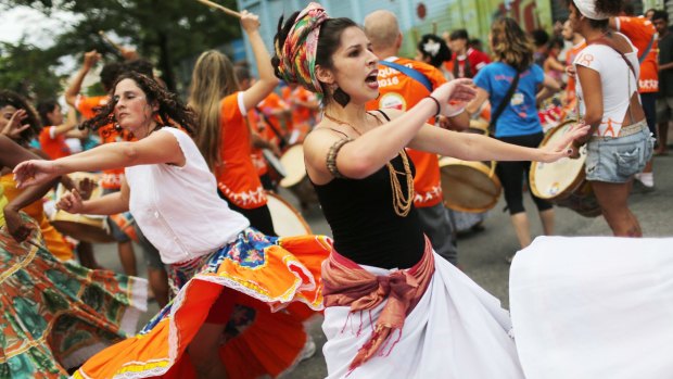 Dancers from the traditional Brazilian folkloric performance group Rio Maracatu perform during their first pre-Carnival street practice last November.