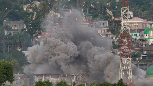 Debris and smoke rises after Philippine Air Force fighter jets bombed suspected locations of Muslim militants in Marawi city, southern Philippines, earlier this month.