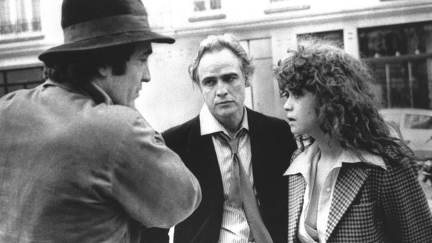 In this 1972 file photo originally provided by United Artists, Director Bernardo Bertolucci, left, Marlon Brando and Maria Schneider are shown during the filing of <em>Last Tango in Paris</em>.