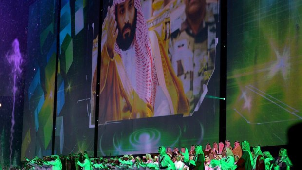 Saudi men perform under a giant screen showing an image of Saudi Crown Prince Mohammed bin Salman during National Day ceremonies last month.