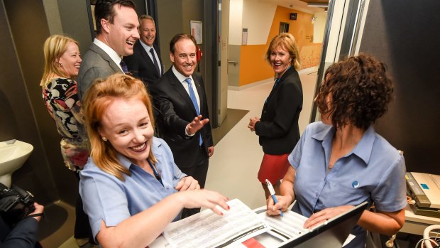 Greg Hunt laughs after two nurses said they were too busy to speak with him following his appointment as Health Minister.