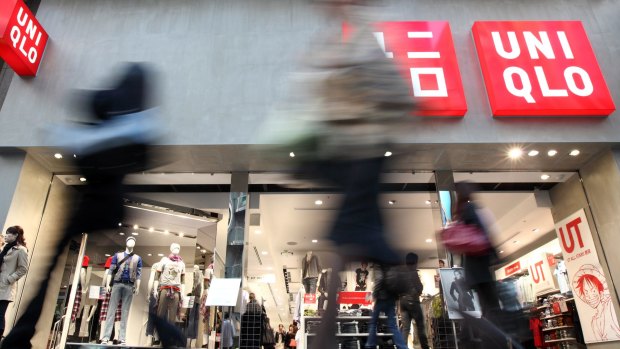 Pedestrians walk past Fast Retailing Co's Uniqlo store in the Ginza district of Tokyo, Japan.