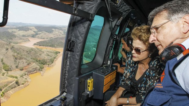 Brazilian President Dilma Rousseff, accompanied by Minas Gerais state governor Fernando Pimentel, looks out over the dam site.