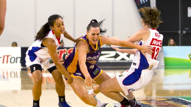 Melbourne Boomers' guard Tess Madgen attempts to dribble through an Adelaide double team.