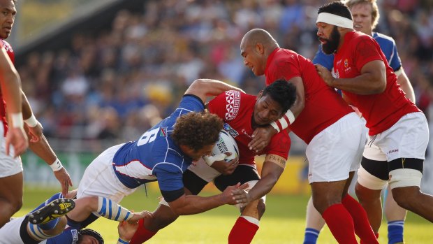 Tonga's Jack Ram is tackled by Namibian captain Jacques Burger.