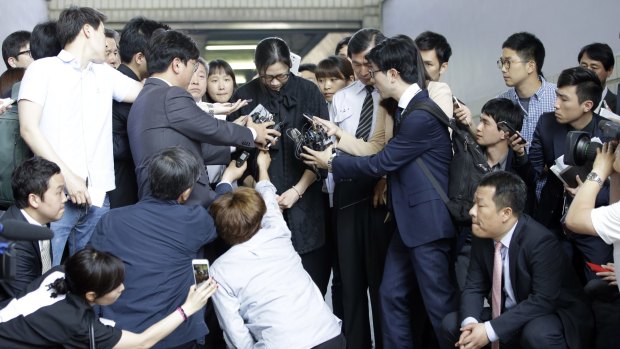 Former Korean Air executive Cho Hyun-ah surrounded by reporters at the Seoul High Court on Friday.
