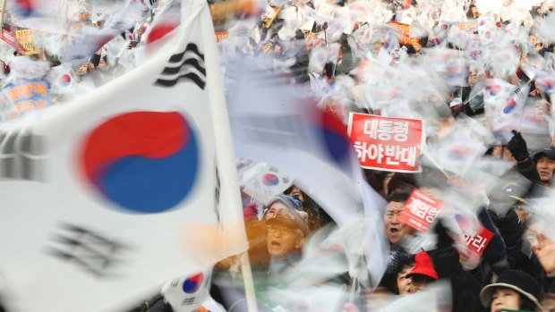 Supporters of South Korean President Park Geun-hye wave their national flags during a rally opposing her impeachment in Seoul, South Korea on December 31.