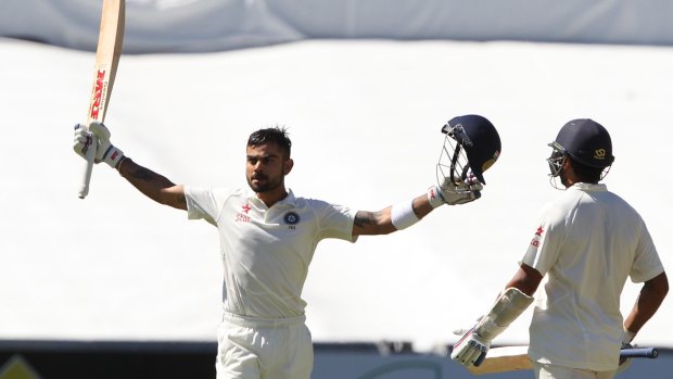 Centurion: India's Virat Kohli after reaching a century as teammate Murali Vijay looks on during the final day of their Test against Australia in Adelaide.