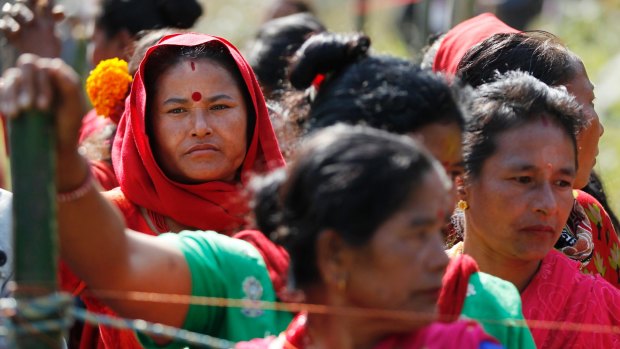Nepalese women wait in line to cast their votes. In mountain villages and Himalayan foothill towns people hope the election will bring government closer to rural and remote areas. 