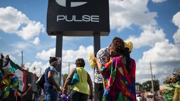 Wayne Dominici, 23, cries on the shoulder of his aunt, Ada Dominici, at a memorial outside Pulse, the gay nightclub where a shooter killed 49 and wounded many more exactly in Orlando, Florida, last month.