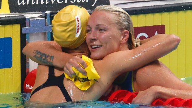 Changing of the guard: Sarah Sjostrom hugs Australia's Emma McKeon after winning gold in the women's 100-metre butterfly final in Budapest.