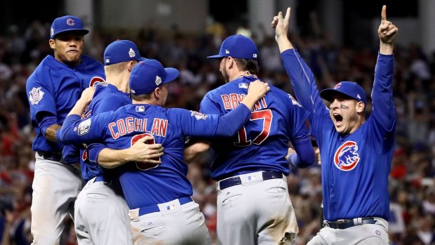 Drought-breakers: The Chicago Cubs celebrate after a marathon rain-affected decider against Cleveland.