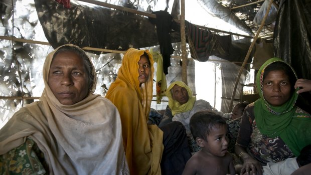 Women and children in a makeshift house they share with six others in a Rohingya refugee camp in Cox's Bazar, Bangladesh, after fleeing from Myanmar's Rakhine state.