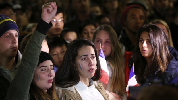People gather and sing the French national anthem at a Sydney vigil for the victims of the Bastille Day attack.