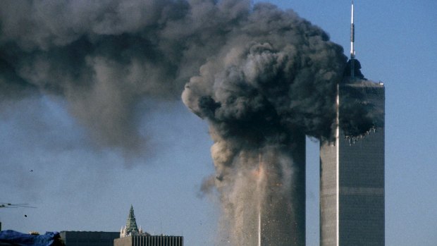 Smoke rises and debris falls from the World Trade Center south tower on September 11.