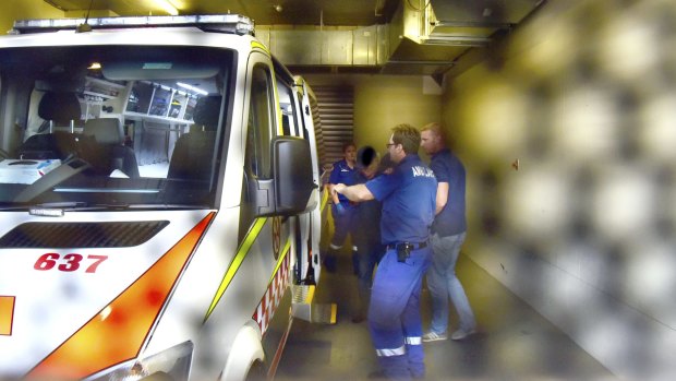 Gino Stocco is taken from Dubbo police station to hospital by ambulance.