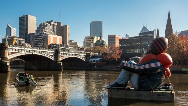 Artwork called Inflatable Refugee, pictured on the Yarra River on Saturday, is touring the globe to highlight the plight of the world's 65 million displaced people.