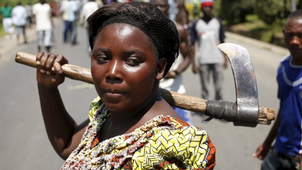 A female protester holds an ax during a protest against Burundian President Pierre Nkurunziza's decision to run for a third term in Bujumbura, Burundi.