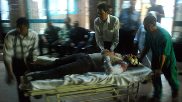 A wounded man arrives at a hospital after a bomb exploded in Cairo.