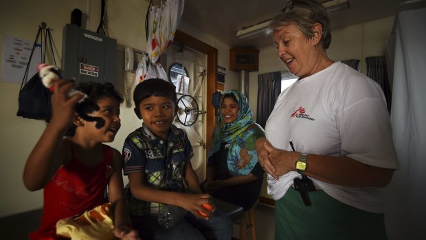 Carol Nagy with Fatma, 4, Mohamed, 6, and their mother Nasma, on-board the MY Phoenix.