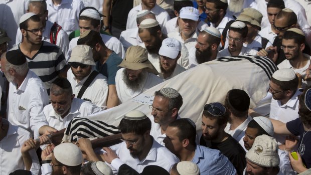 Israeli relatives and friends carry the body of Rabbi Nehemia Lavi at his funeral in Jerusalem.