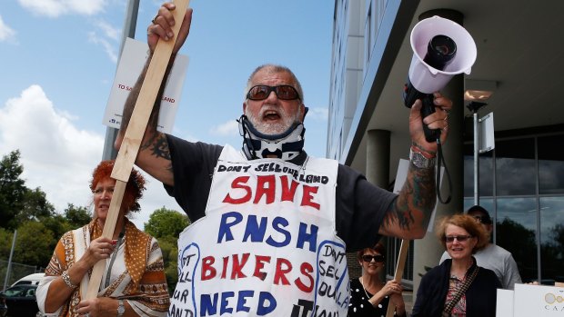 A man protests the sale of public land near the Royal North Shore Hospital at a rally earlier this month.