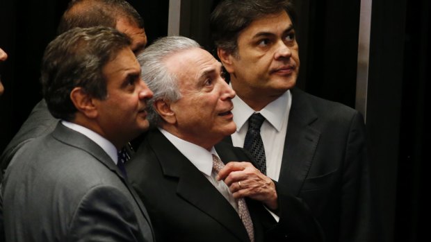 Michel Temer, Senator Aecio Neves and Senator Cassio Cunha Lima look on as Temer is sworn in as Brazil's President on Wednesday.