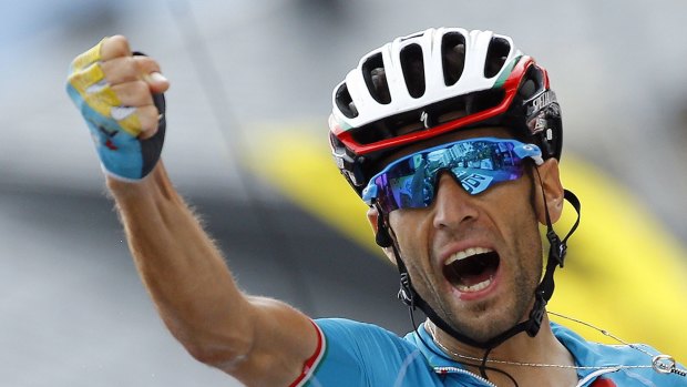 Astana rider Vincenzo Nibali of Italy celebrates as he crosses the finish line to win the 138km 19th stage in La Toussuire in the French Alps.