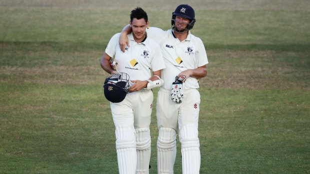 Scott Boland (left) and Cameron White of the Bushrangers leave the field after holding on for a draw against New South Wales on March 18.