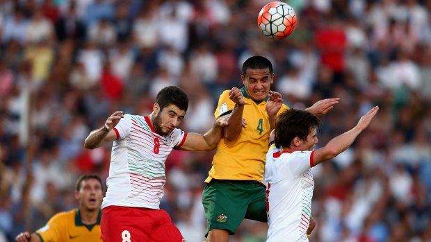 Tim Cahill in an aerial duel with Eraj Rajabov and Nurriden Davronov of Tajikistan during the World Cup qualifier in Dushanbe on Tuesday.