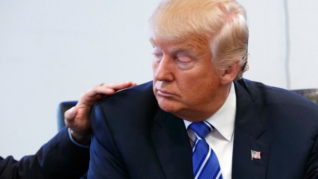 Art Del Cueto, a vice president for the National Border Patrol Council, puts his hand on Donald Trump's shoulder during a security meeting at Trump Tower on Friday.