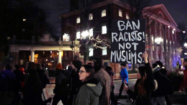 Several hundred people march past the gates of Harvard Yard at Harvard University while protesting the revised travel ban in Cambridge, Massachusetts. 