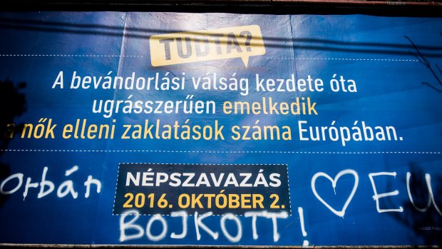 Pro-European Union graffiti calls for a boicott of the referendum on a government poster in Budapest.