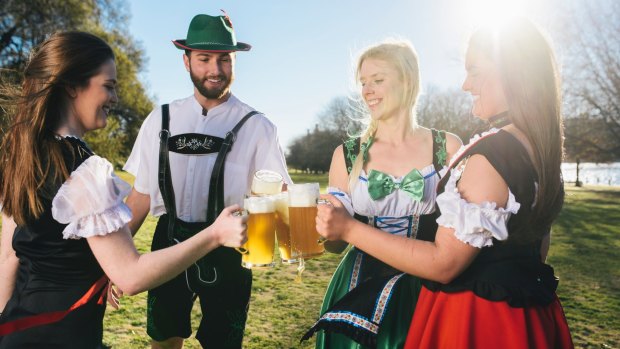 Maddie Welsh, Patrick Gallagher, Zoe Kooyman, and Carly Farmington enjoying a stein at the Patrick White Lawns in Parkes ahead of the new Oktoberfest Parklands.