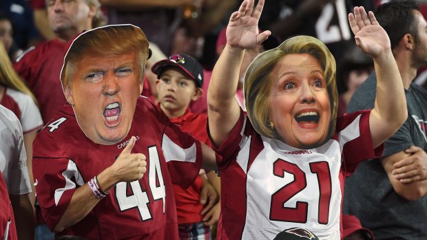 Arizona Cardinals fans wear masks of presidential candidates Donald Trump and Hillary Clinton during an NFL game on Monday.