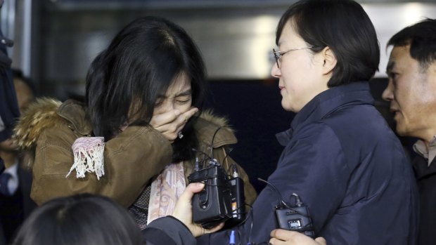 A Korean-American Shin Eun-mi, left, weeps  as she arrives to leave for the United Sates at the Incheon International Airport in Incheon on Saturday.